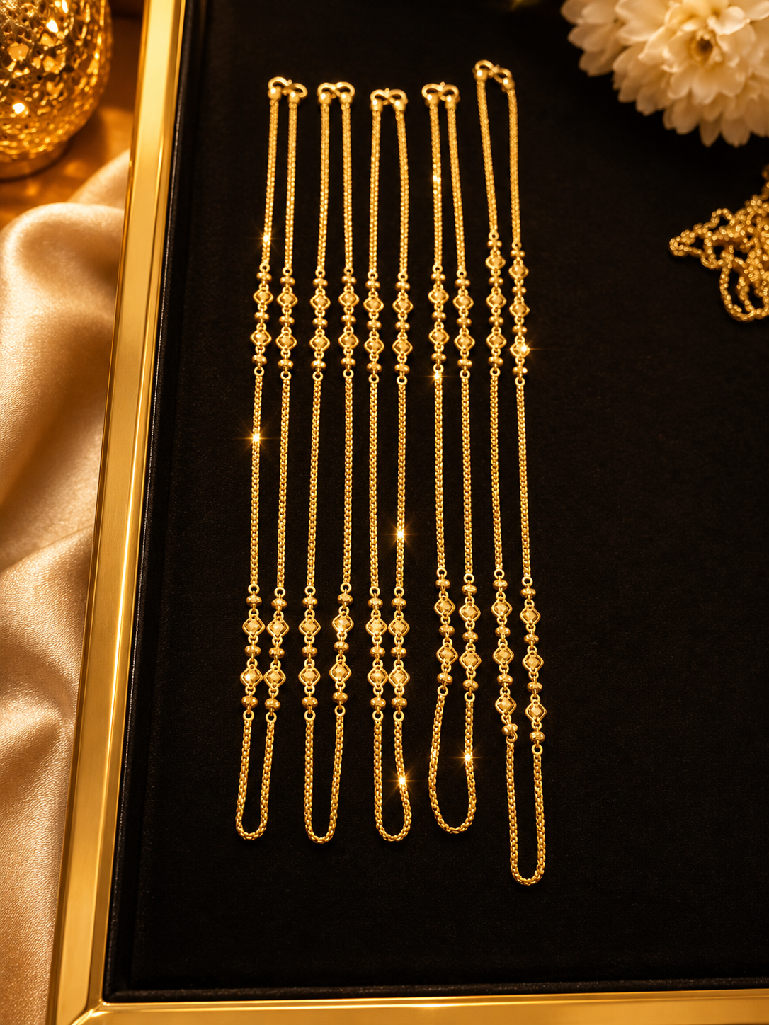 Delicate gold chain collection displayed in a gold frame